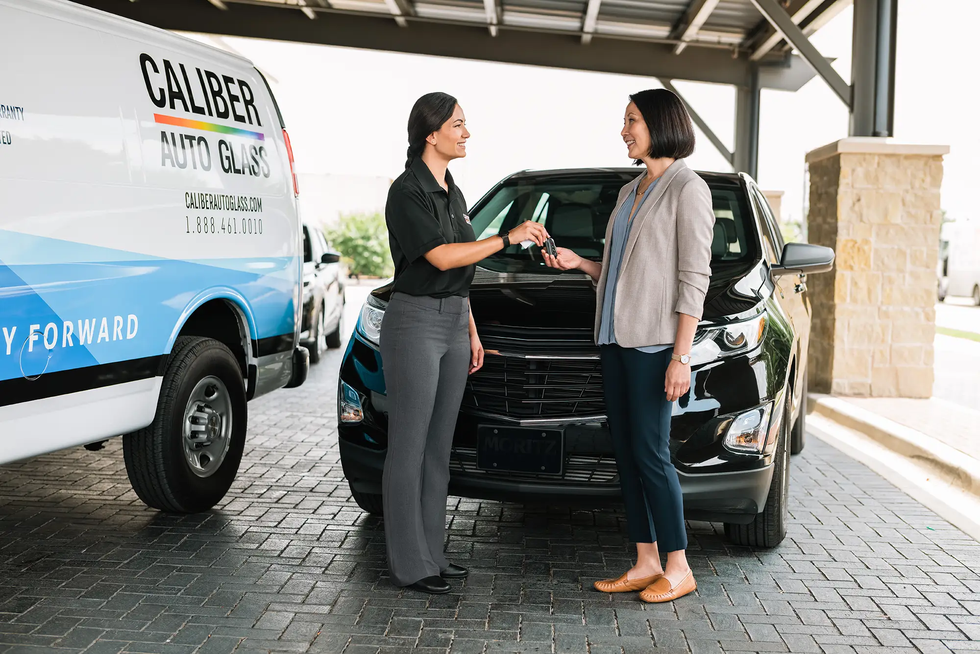 Caliber Auto Glass Repair Tech delivering vehicle to customer after windshield repair.
